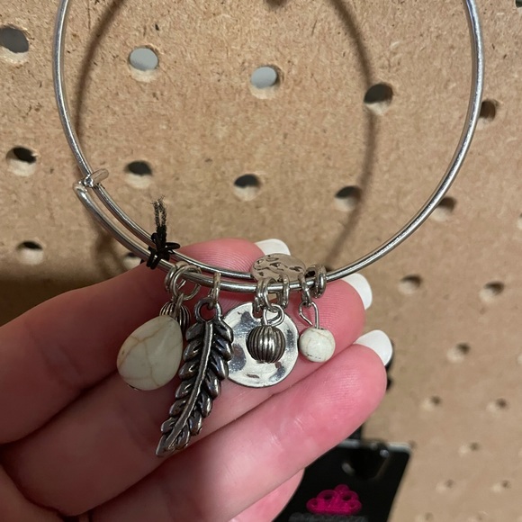 Silver bangle bracelet with a feather, discs, and white crackle stones. - Picture 2 of 3
